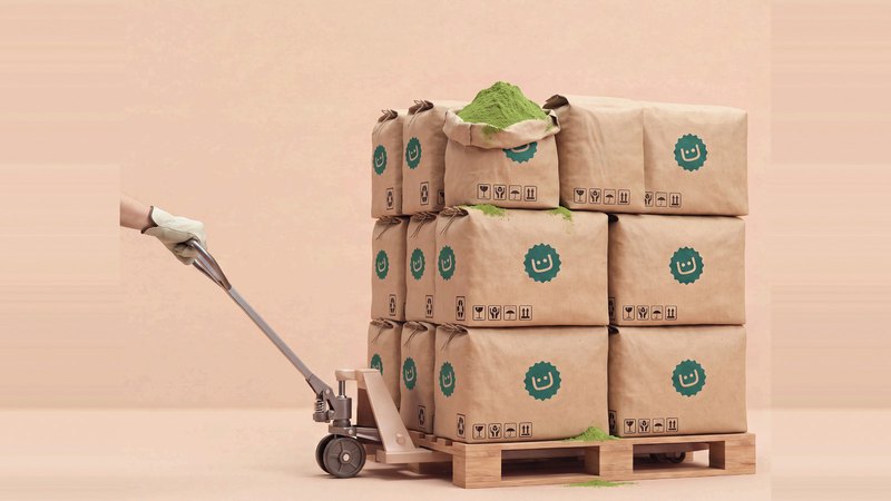 Pallet of bulk matcha bags with one bag open, moved by a pallet jack