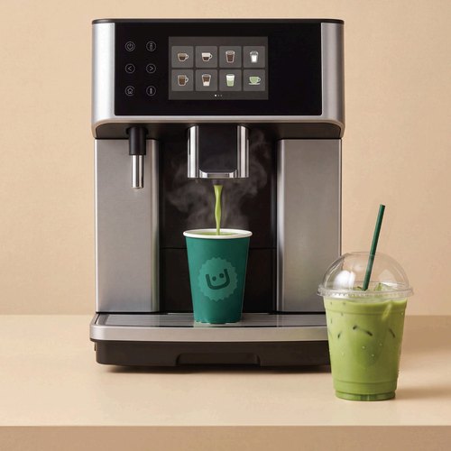 Automatic coffee machine dispensing matcha into a cup