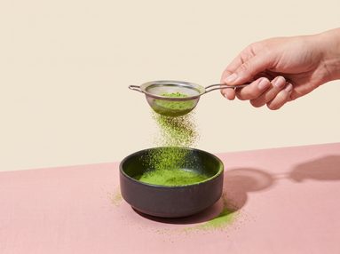 Step 1, sifting matcha powder into a ceramic bowl through a fine sieve