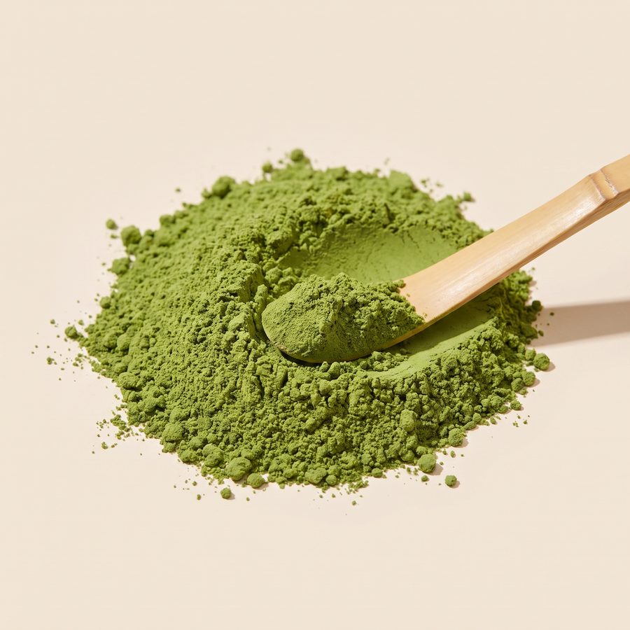 Close-up of fine green Organic Premium Matcha powder with a bamboo scoop