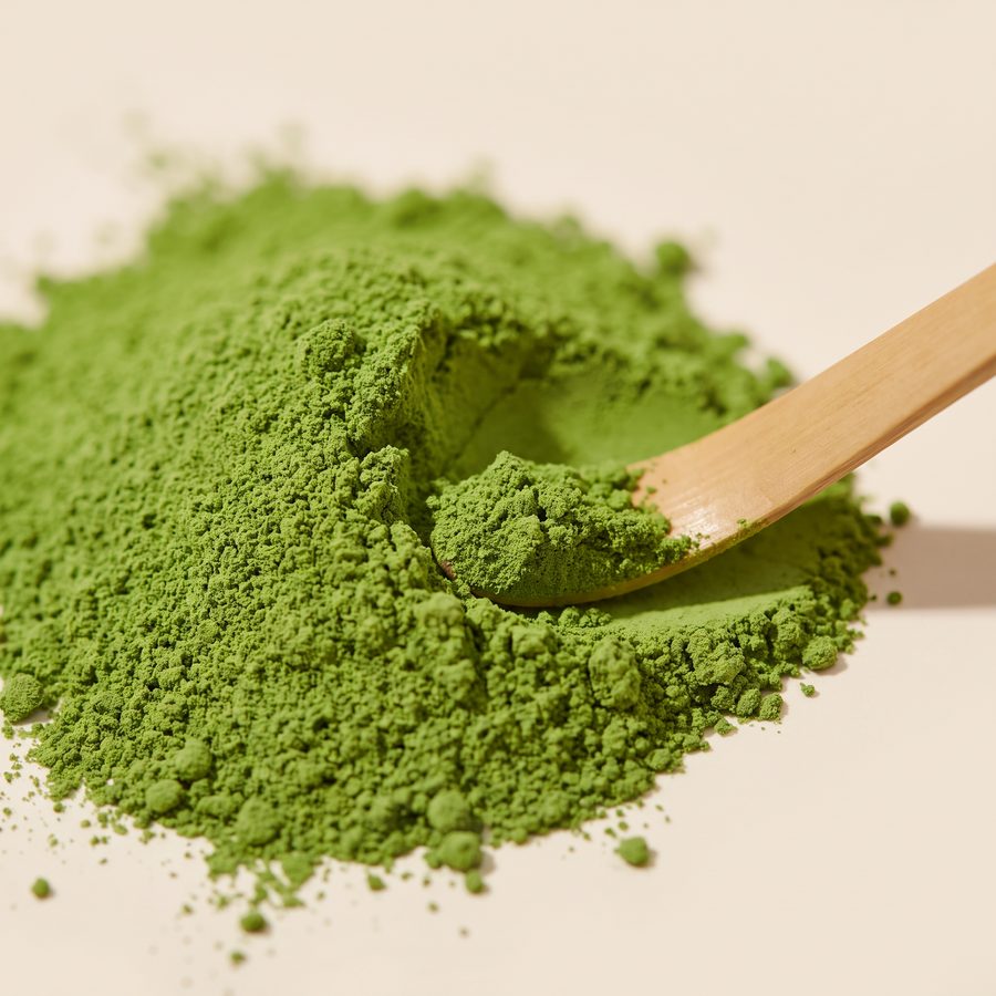 Close-up of fine vivid green Top Grade Organic Ceremonial Matcha powder with a bamboo scoop