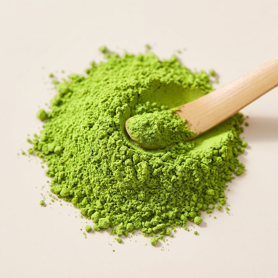 Close-up of fine vivid green Organic Ceremonial Japanese Matcha powder with a bamboo scoop