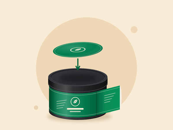 A body label being wrapped around a tin while a round lid label comes down onto the lid